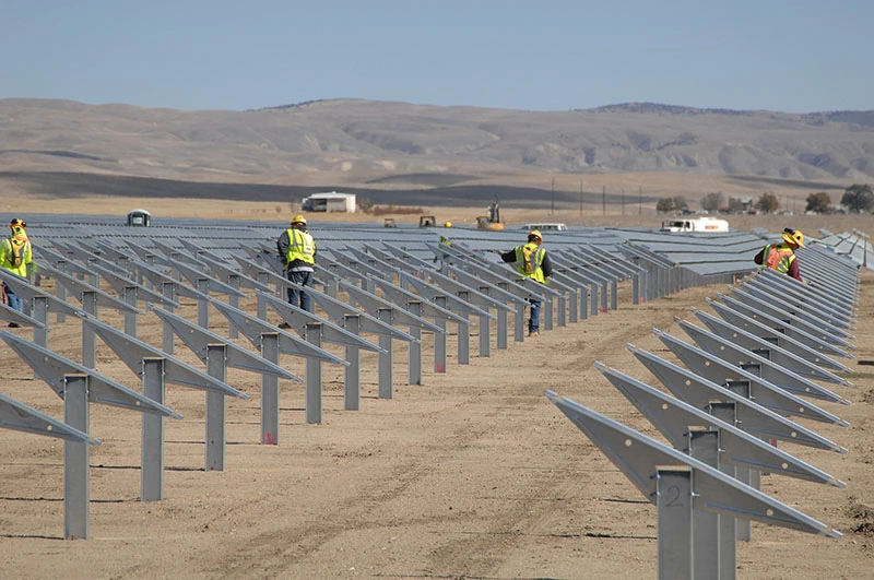 workers building a solar farm